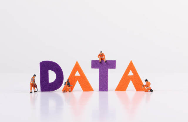 The word Data with tiny workers on white background
