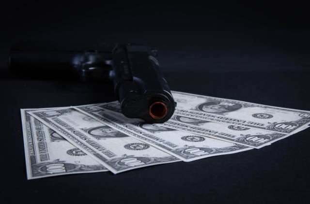 Gun and money concept