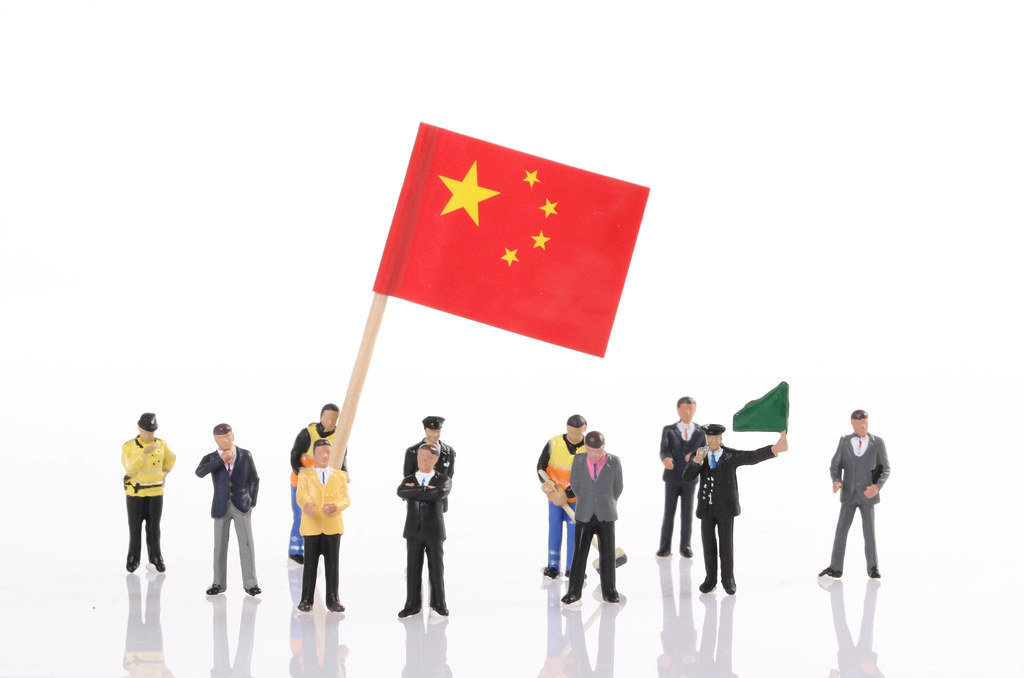 Miniature people with flag of China