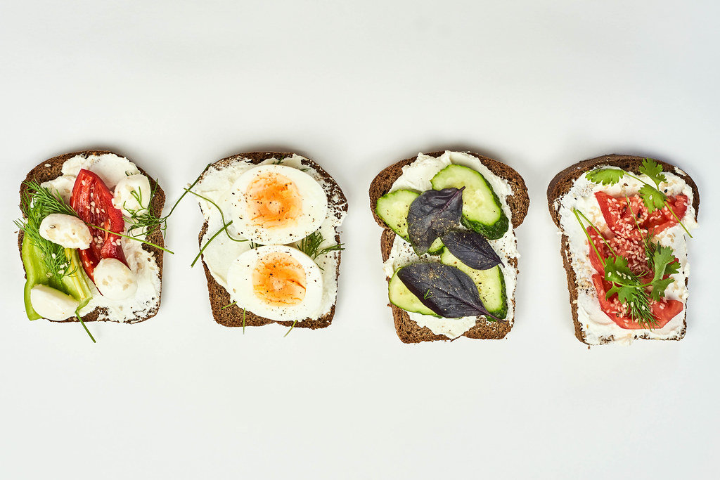 Different dieting toast snacks on white background