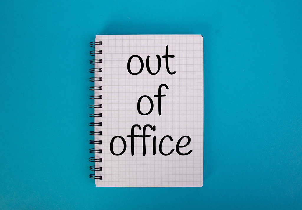 Out of office text written in notebook
