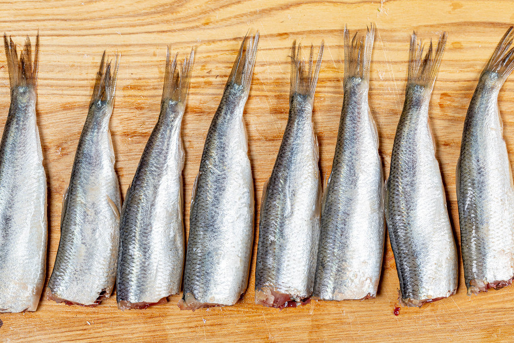 Top view raw fish sprats on the kitchen Board