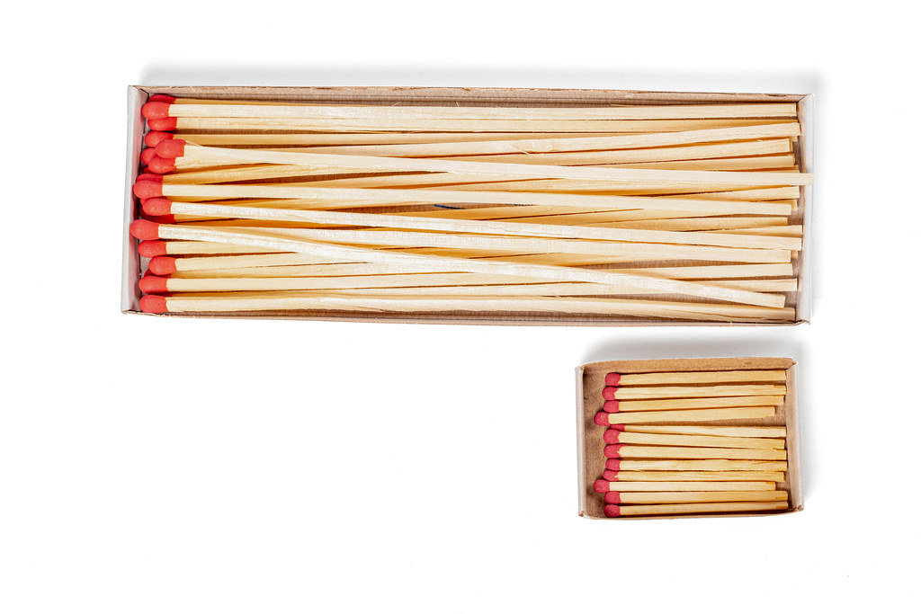 Packages with mantel long and short matches on white, top view