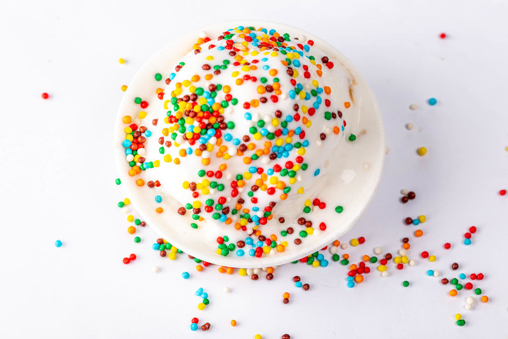 Vanilla ice cream with multi-colored powder. Top view