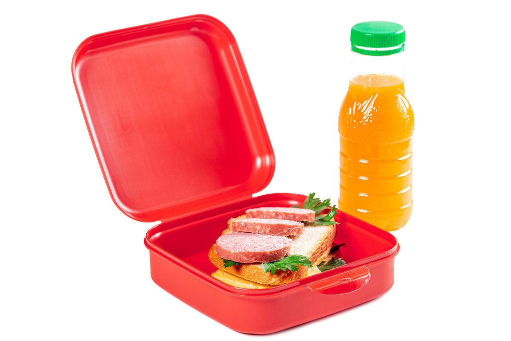 School lunch box - with a fresh sandwich and a bottle of orange juice