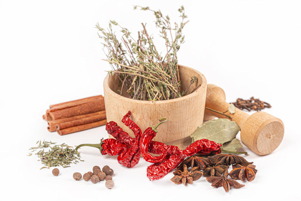 Composition with different spices and mortar on white background