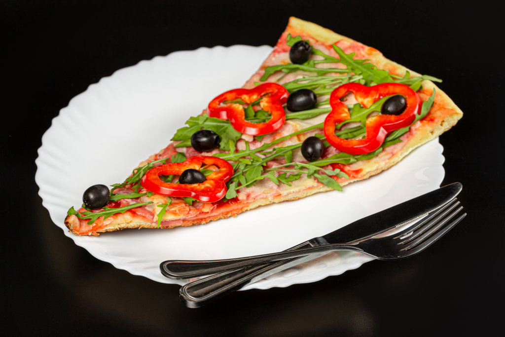 Slice of pizza with ham, cheese, arugula, black olives and bell