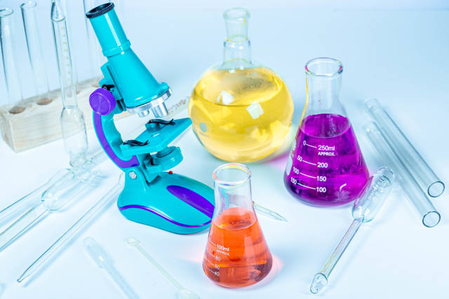 Flasks with reagents, microscope and laboratory glassware