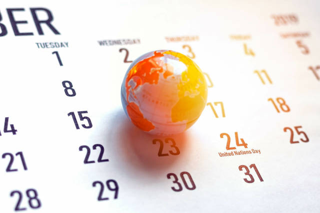United Nations Day. October calendar and miniature globe of the world. 24th October marked on calendar