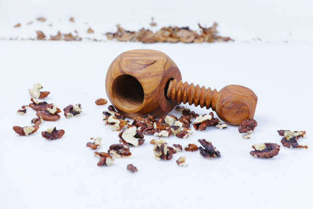 Walnuts and nutcracker on a white background