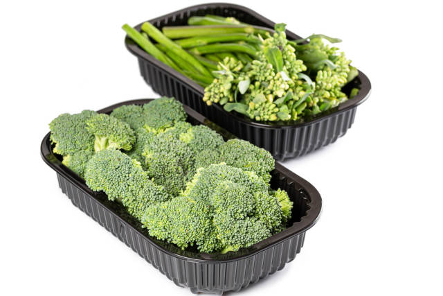 Containers with fresh broccoli and broccolini on white background