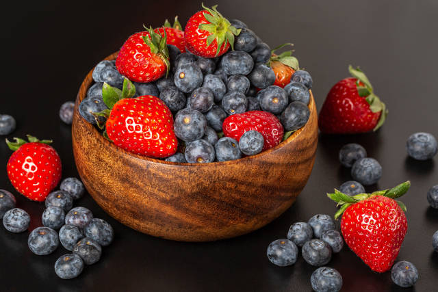 Ripe berries of strawberries, blueberries and raspberries in a w