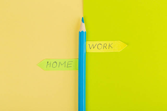 A pointer made of pencil and paper, the concept of choosing between home and work