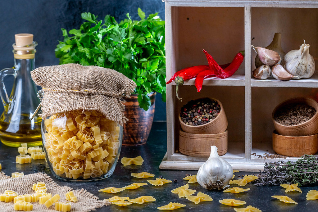 Food background with spices, herbs and pasta