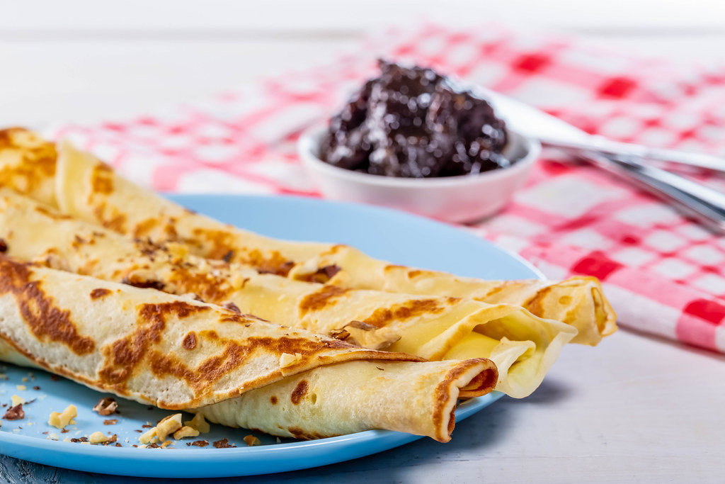 Close-up of pancakes with walnuts and plum jam