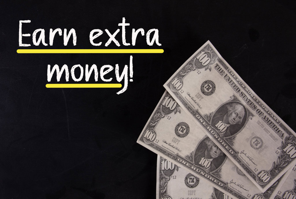 Dollar banknotes with Earn extra money text