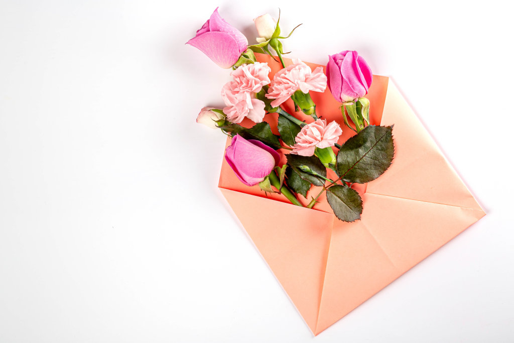 Carnations and roses with pink envelope