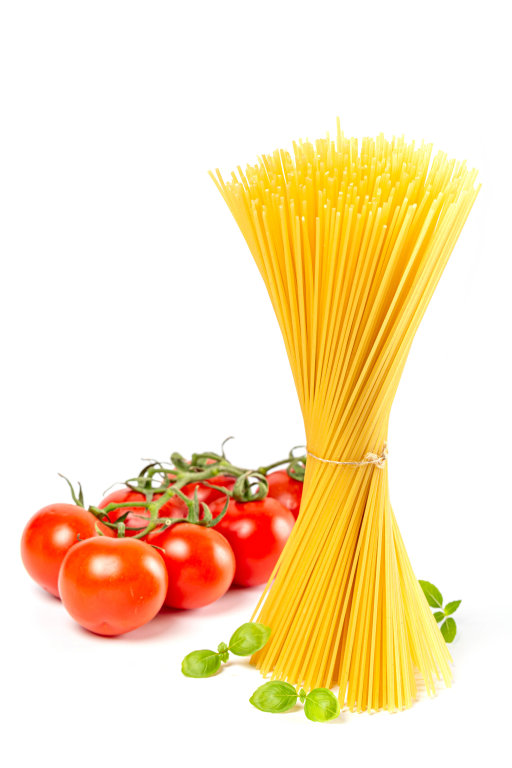Bunch of dry spaghetti with fresh tomatoes on white background