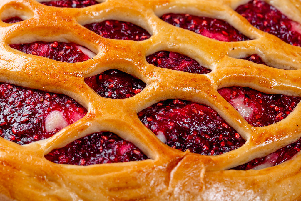 Raspberry pie with raspberry jam close up