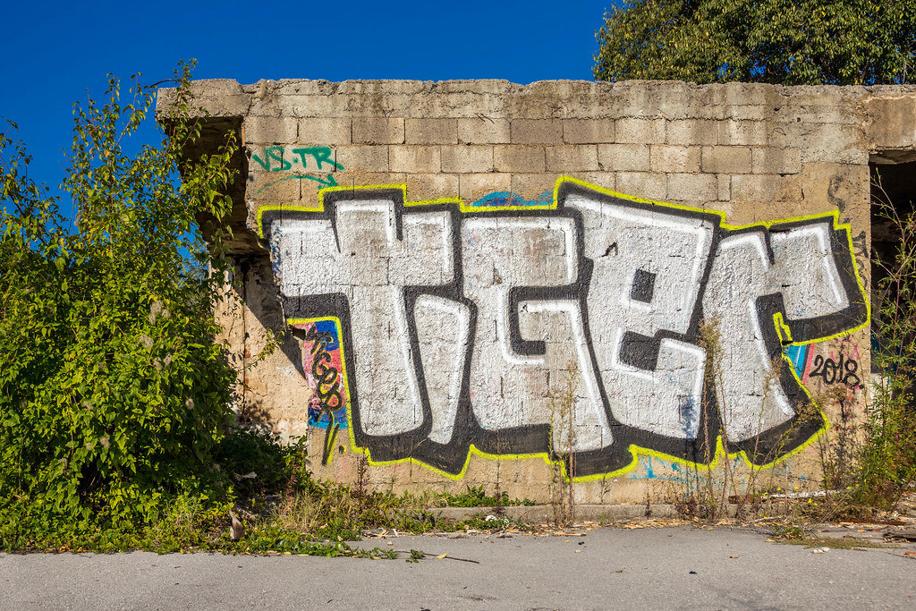 Street art, graffiti on the wall of abandoned ruin
