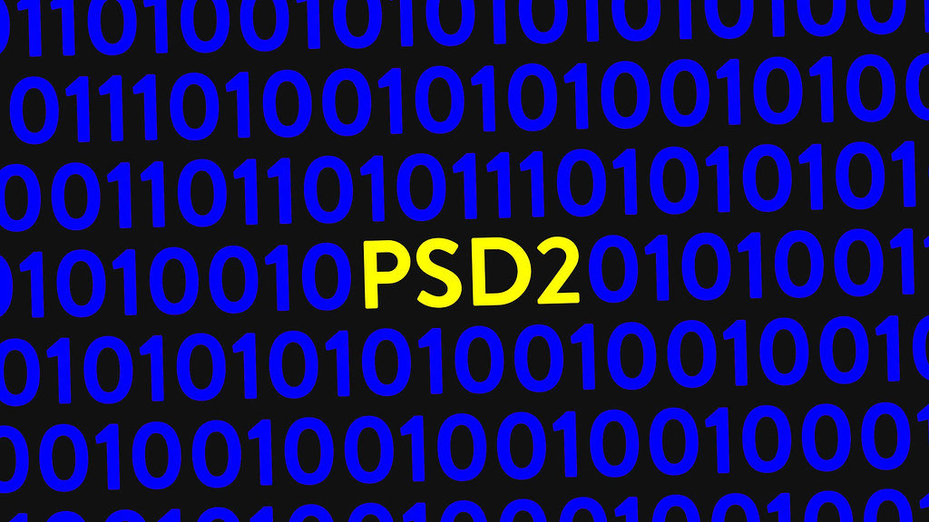Blue binary code on screen with text PSD2