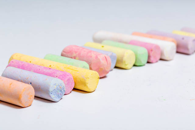 Crayons of different colors on white background