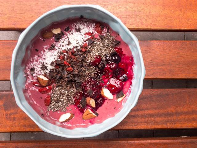 Acai bowl with chocolate, berries, almonds and coconut