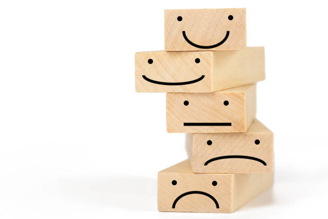 Wooden blocks with symbols - smilies expressing different emotions