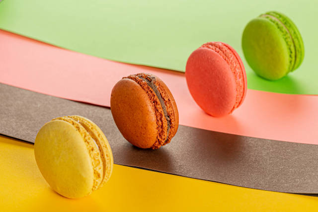 Colorful dessert background with multicolored macaroons