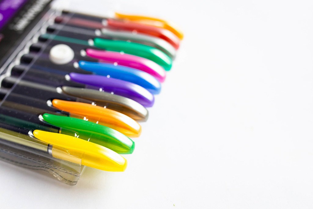 Pack of neon colored pens on white background
