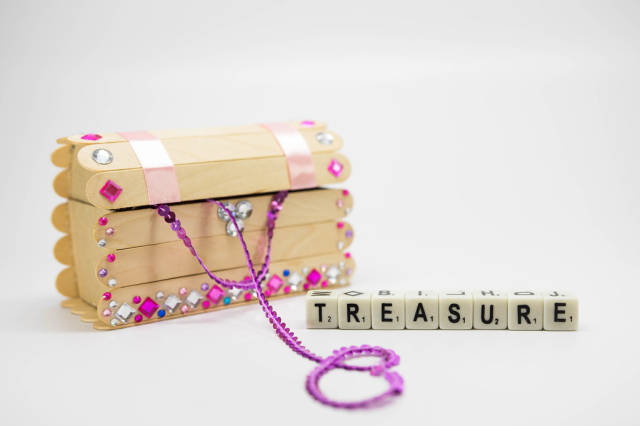 Treasure chest with dice reading TREASURE