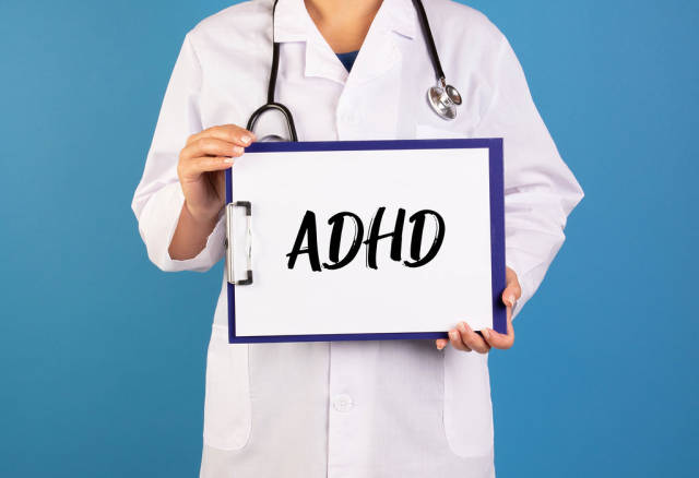 Doctor holding clipboard with ADHD text