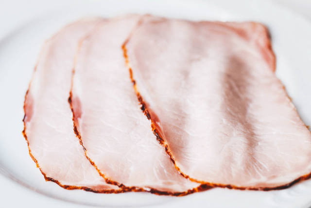 Ham slices on white background Close up