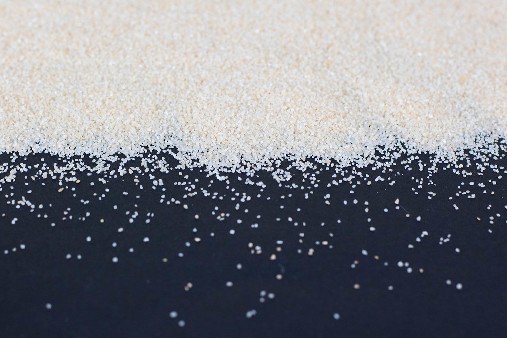 White sand on black background