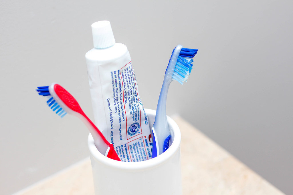 Toothbrush in a White Bowl with Toothpaste