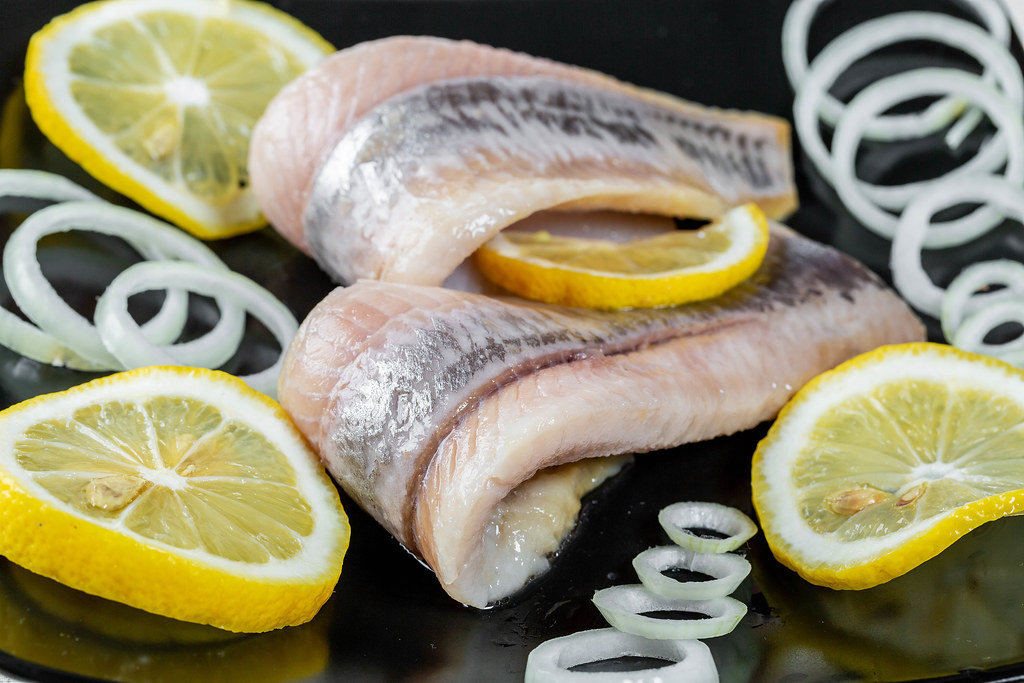Fillet of pickled fish with lemon and onion