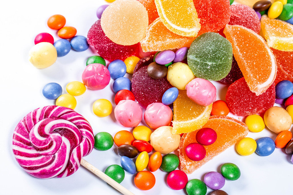 Colorful candies, jelly and marmalade on white background. Top view