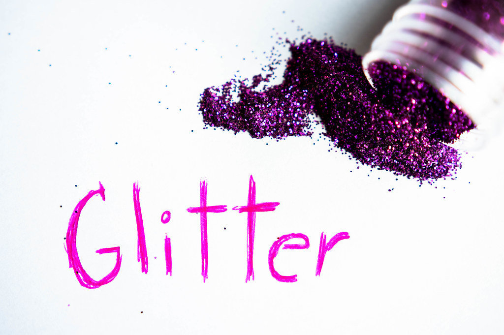 GLITTER written on a white paper