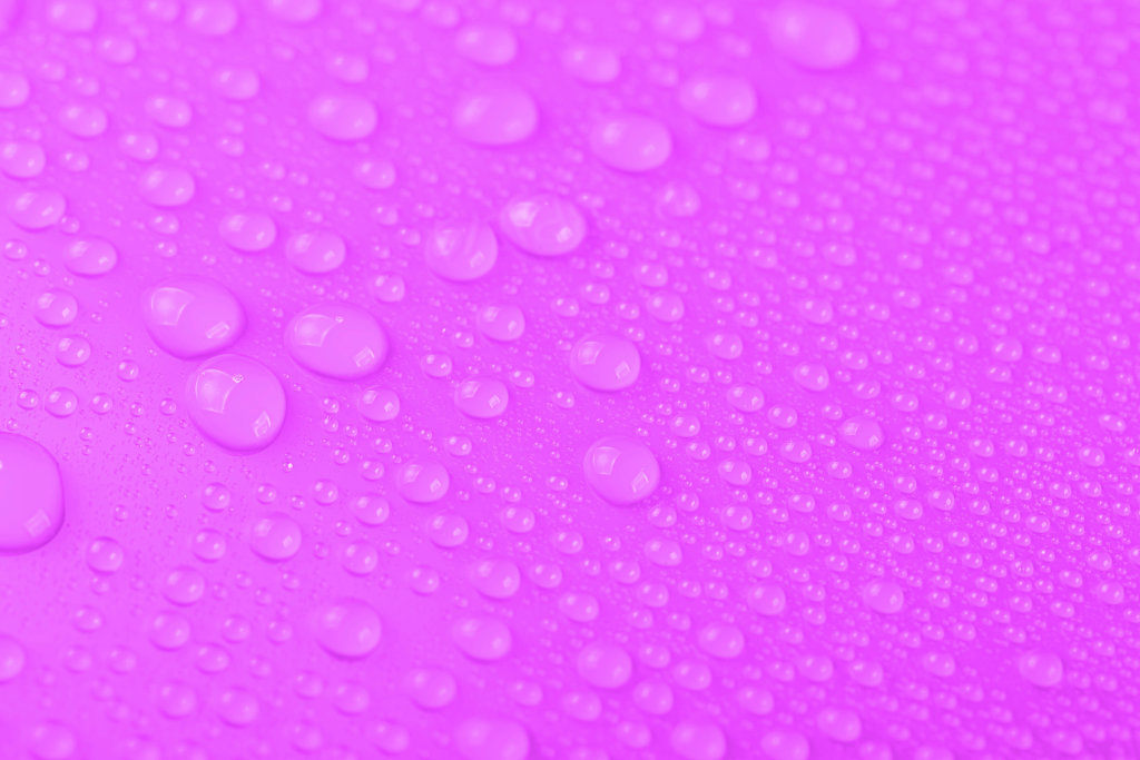 Water drops over pink, closeup