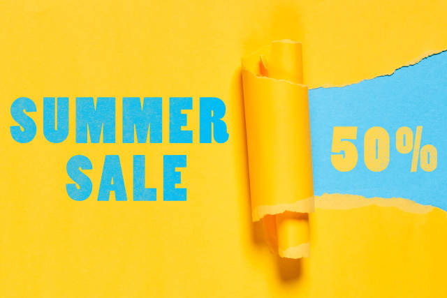 Summer sales with 50 percent discount on paper hole with torn edges