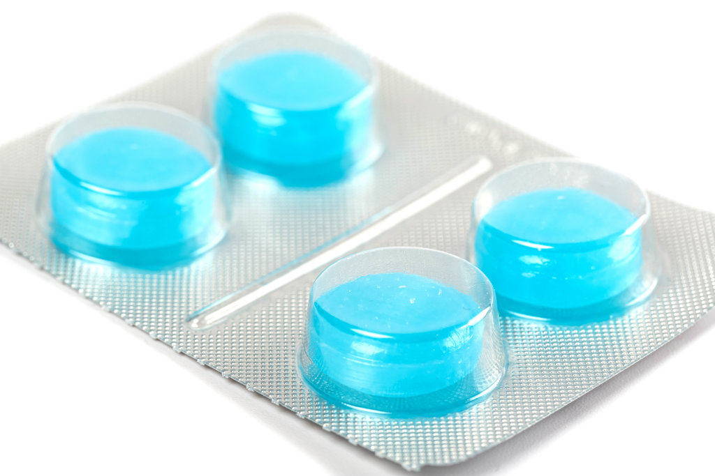 Blue medicinal lollipops in a package, close-up