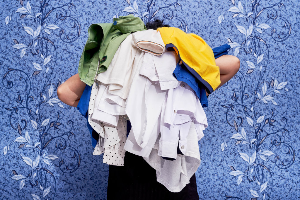 Housewife holding a pile of laundries