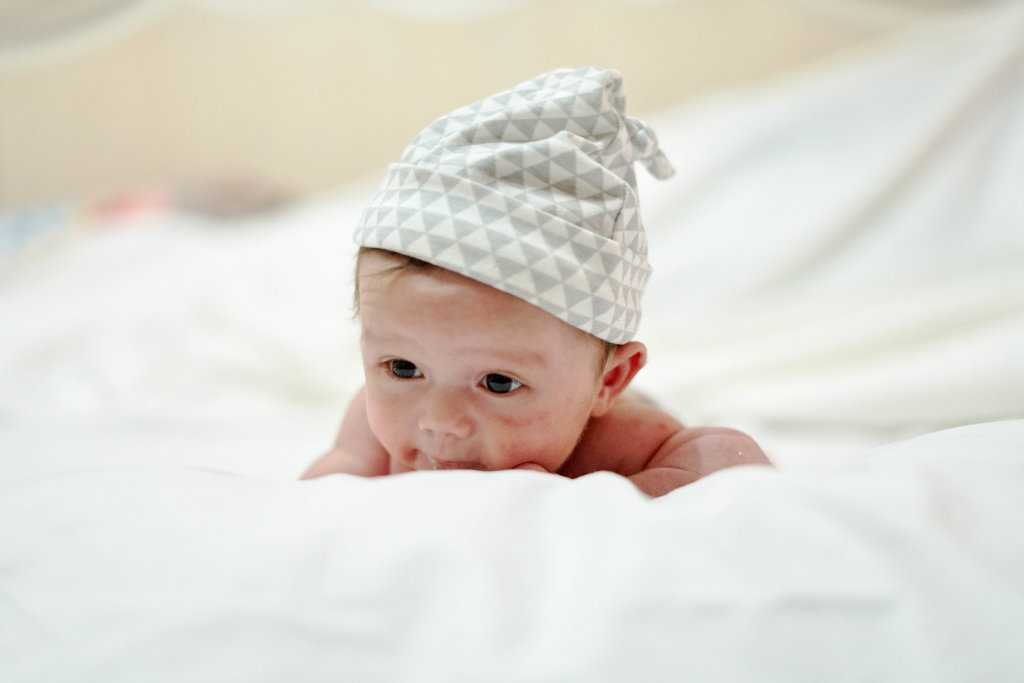Newborn baby beginning to pick up his head on his own