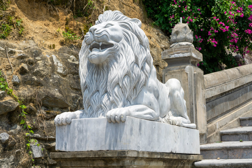White Marble Lion Statue with Large Mane on the Beginning of the Stiarway to Linh Ung Pagoda on Son Tra Peninsula in Da Nang, Vietnam