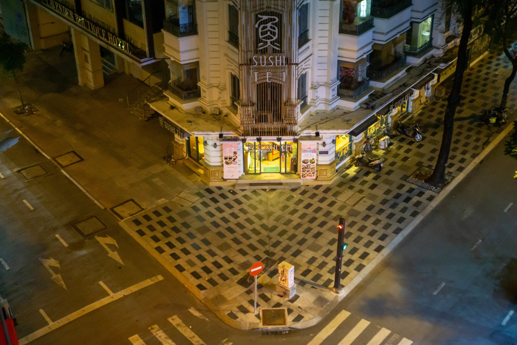 Top View Photo of Sushi Tei Restaurant with Empty Street and Sidewalk in the City Center in District 1 in Ho Chi Minh City, Vietnam