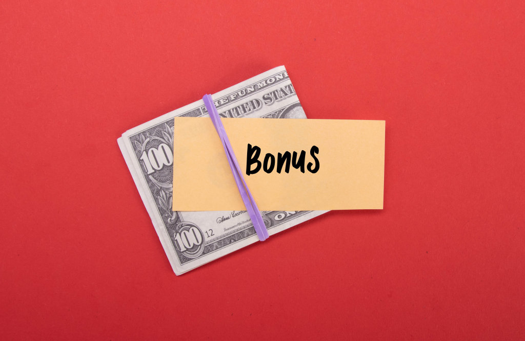 Money stack with Bonus text on red background