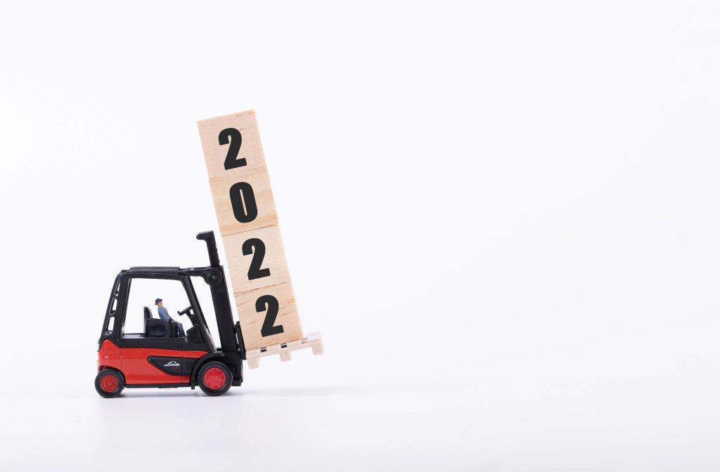 Red forklift with wooden block and 2022 text
