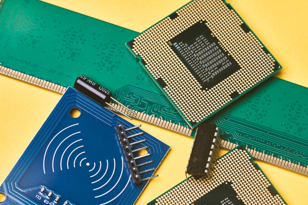 Pile of integrated circuit chips and semiconductors on yellow background - Global microchip shortage