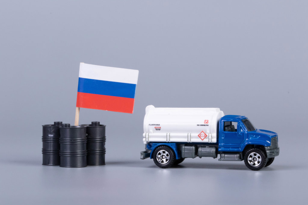 Oil truck and oil barrels with flag of Russia