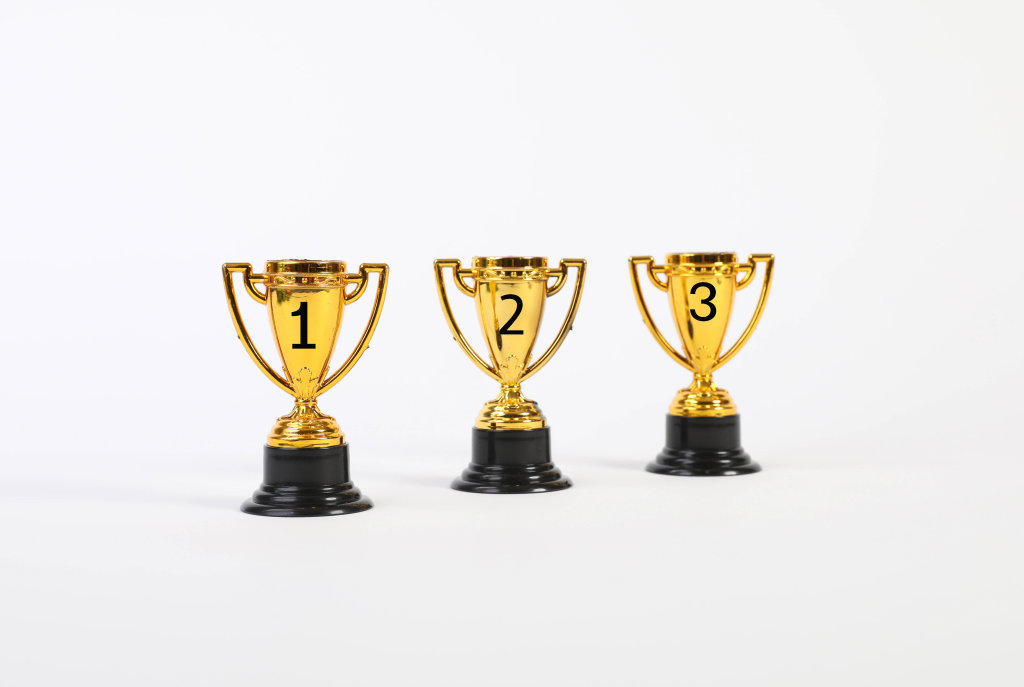 Set of golden trophies on white background